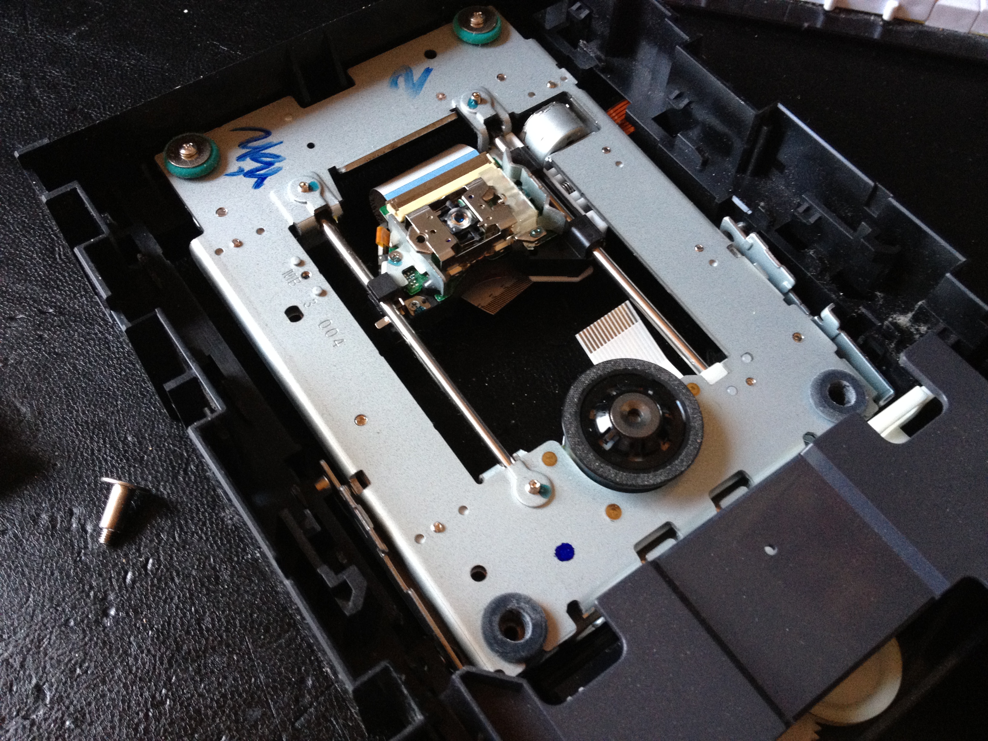 Full view of the opened 16x DVD burner mechanism with the laser sled and optics assembly visible in the center
