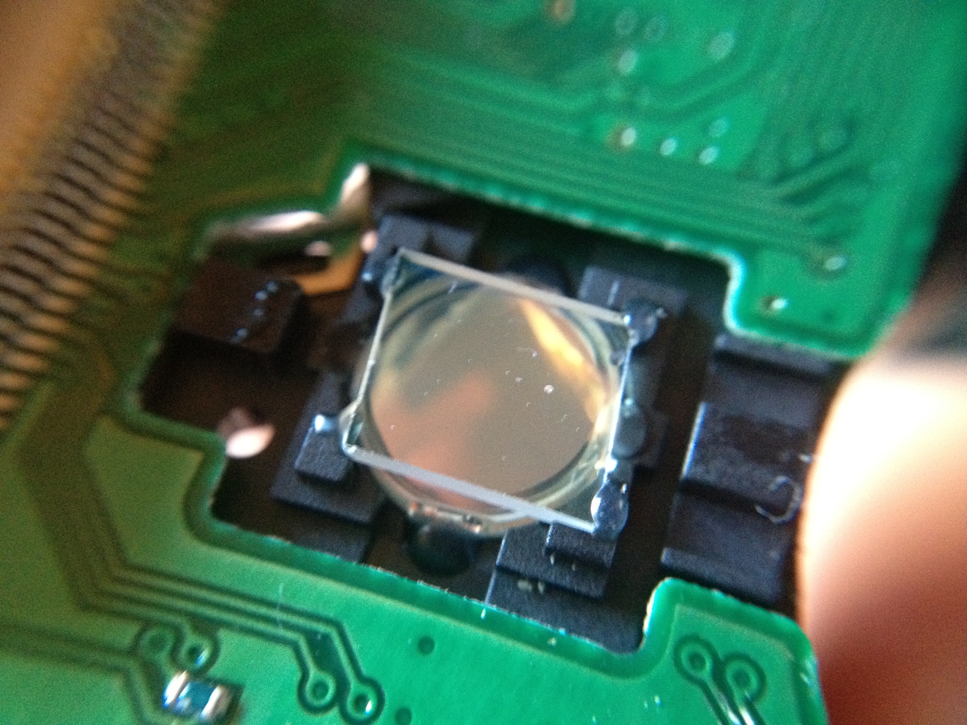 Macro close-up of the small collimating lens used to focus the laser diode beam